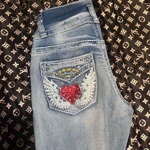 Y2K bootcut jeans with bedazzled heart & wings on back pockets.